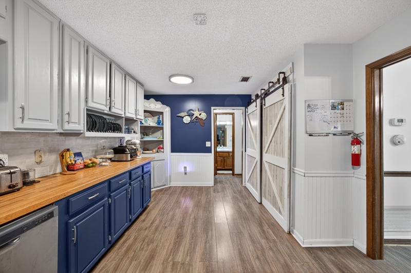 Kitchen and laundry area with blue cabinets at 981 Marble Ridge Dr, Orange Park, FL 32065