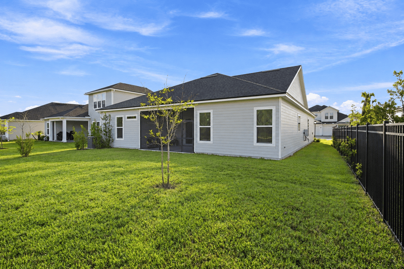Side yard with screened patio and privacy fence at 27 Holly Rdg Wy, St. Augustine, FL