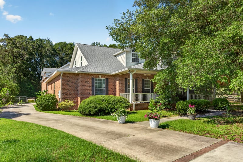 Brick front exterior with long driveway at day-to-dusk at 1735 Hagans Ridge Ct