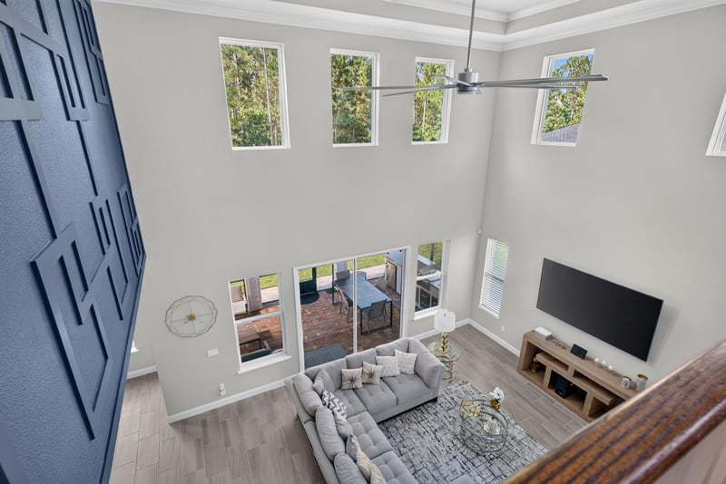 Loft area with tall windows at 22 Azura Point