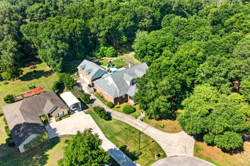 Aerial view of the property among wooded lots at 1735 Hagans Ridge Ct
