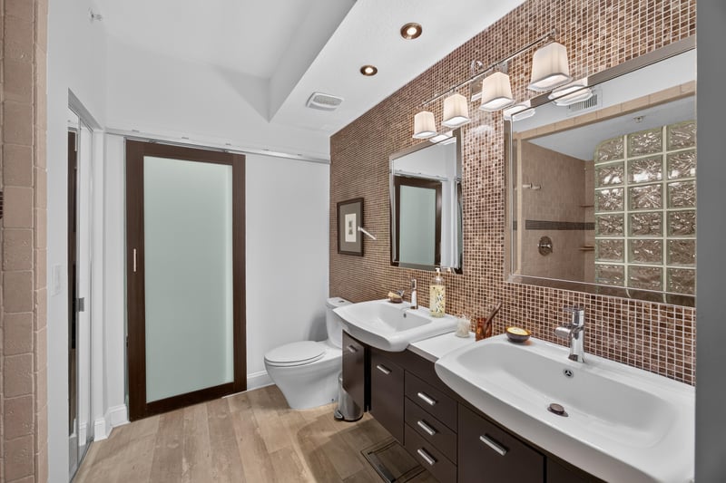 Primary bathroom with dual vanity and tile walls at 10435 Mid Town Pkwy unit 135, Jacksonville, FL 32246