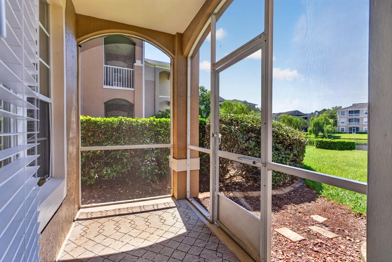 Screened porch overlooking lawn and buildings at 7990 Baymeadows Rd E #404, Jacksonville, FL 32256