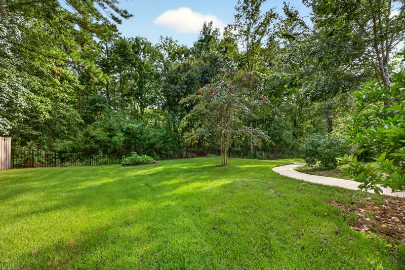Wooded backyard with stone path at 2125 Blue Heron Cove Dr, Orange Park, FL 32003