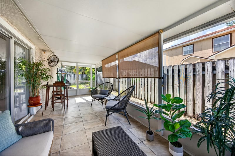 Screened porch with outdoor seating area at 12825 Kelsey Island Dr, Jacksonville, FL 32224