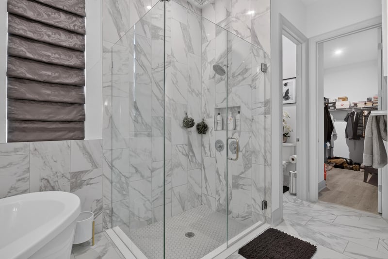 Primary bathroom glass shower and freestanding tub at 785 Back Creek Dr, St. Augustine, FL 32092