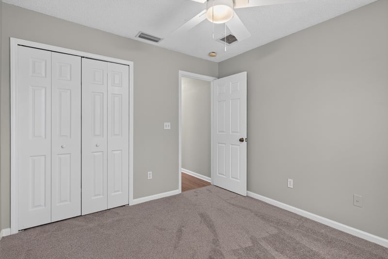 Bedroom with closet doors at 12949 Chets Creek Dr S, Jacksonville, FL 32224