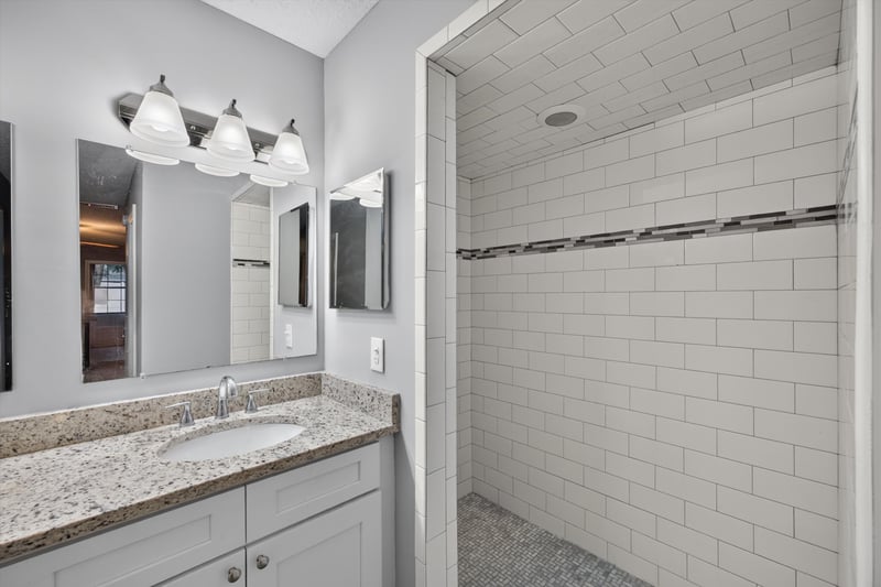 Bathroom vanity and walk-in tiled shower at 12344 Cormorant Ct, Jacksonville, FL
