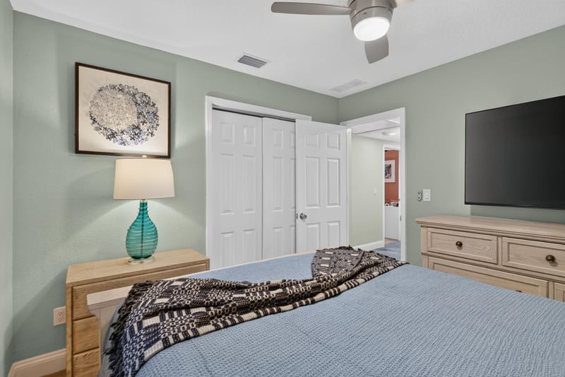 Bedroom with blue walls and wall-mounted TV at 1525 8th St N, Jacksonville Beach, FL