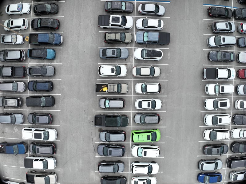 Aerial view of parking lot with green landscaping strip at 9406 Atlantic Blvd, Jacksonville, FL 32225