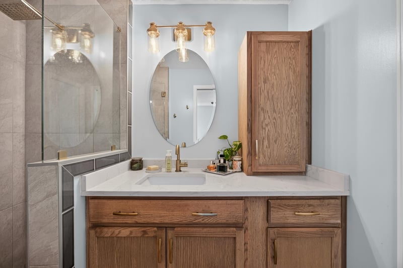 Bathroom vanity with round mirror at 1589 Backwater Drive, Middleburg, FL 32068