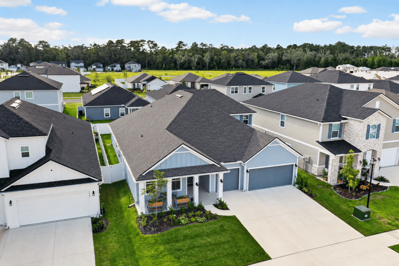 Aerial view of the home among neighboring rooftops in Middleburg, FL