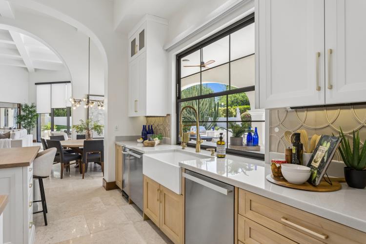 Kitchen with a stone waterfall island and white oak cabinetry, Paradise Valley