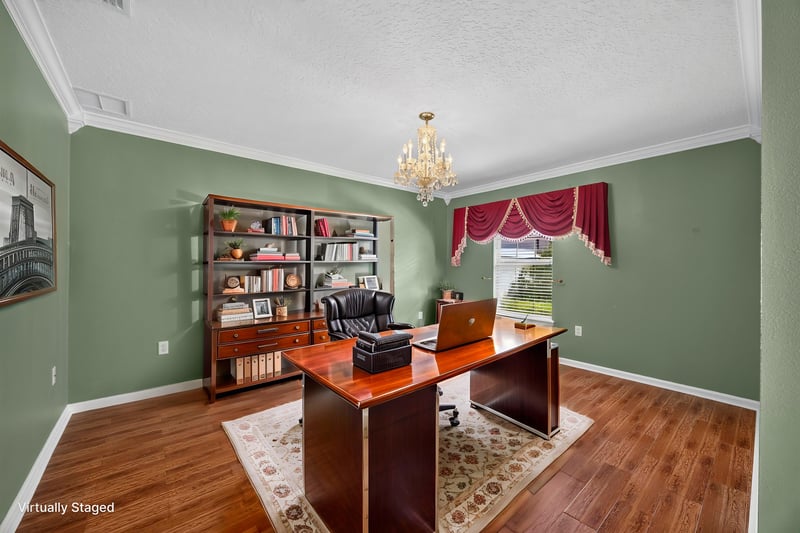 Virtually staged home office with bookshelf and desk at 2282 Justin Lake Dr, Jacksonville, FL