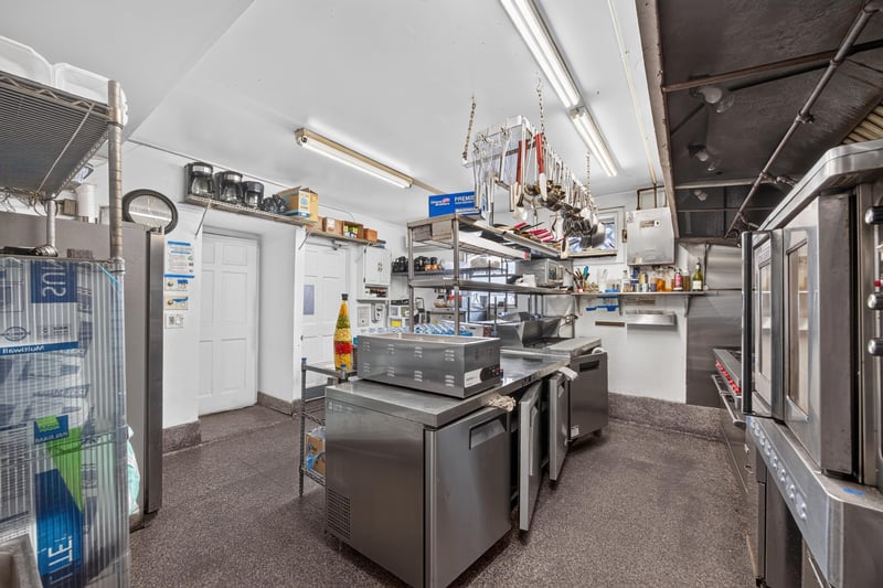 Kitchen storage shelving and equipment at 115 Cordova St, St. Augustine, FL