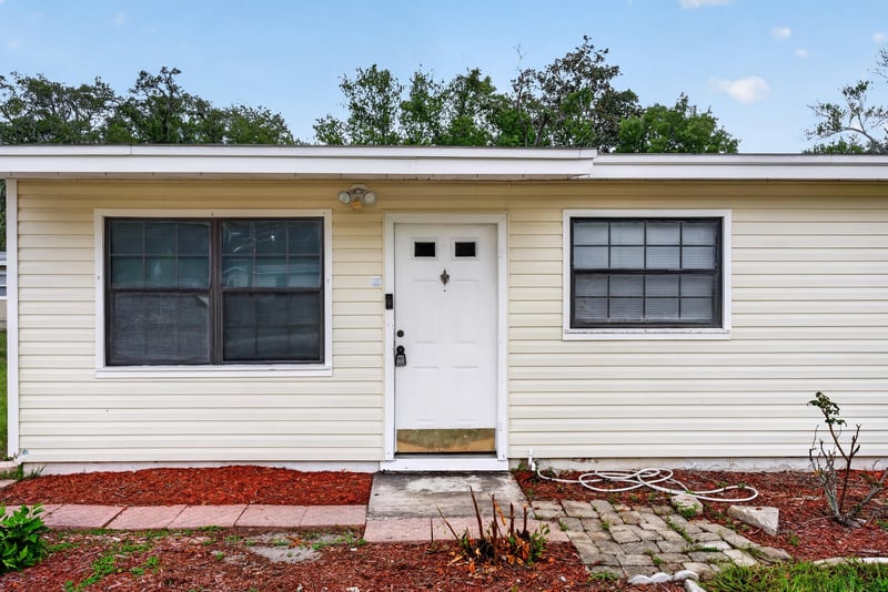 Front door close-up with black-trimmed windows at 255 Woodside Dr, Orange Park, FL 32073