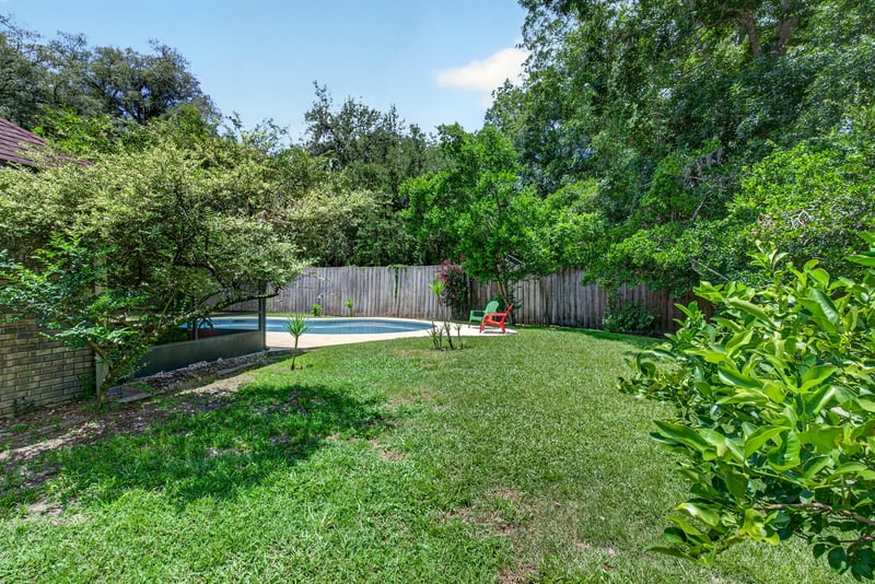 Fenced backyard with pool and lawn at 12810 Swamp Owl Ln