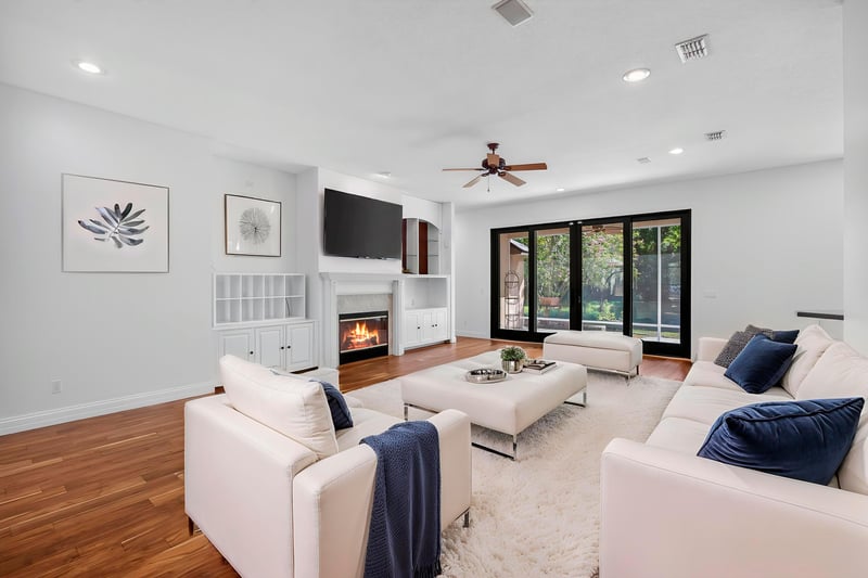 Living room with fireplace and large windows at 11675 Magnolia Estates Rd, Jacksonville, FL 32223