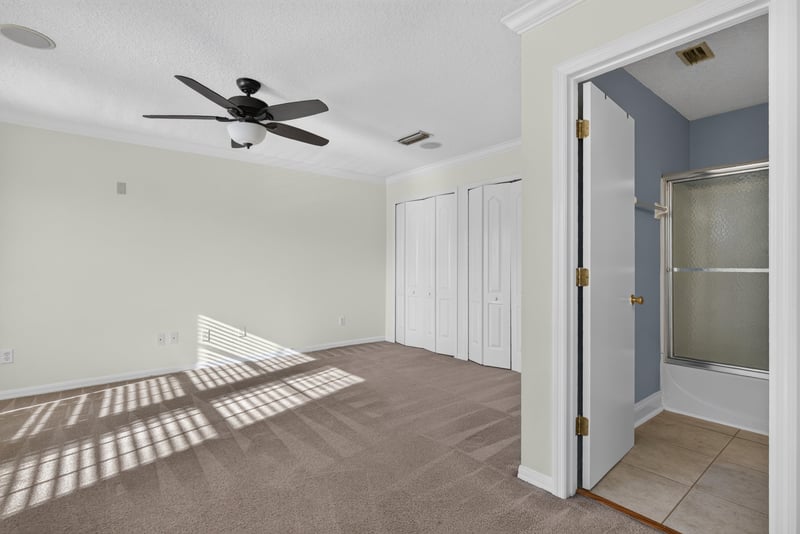 Hallway with ceiling fan and closet doors at 353 Redwood Ln