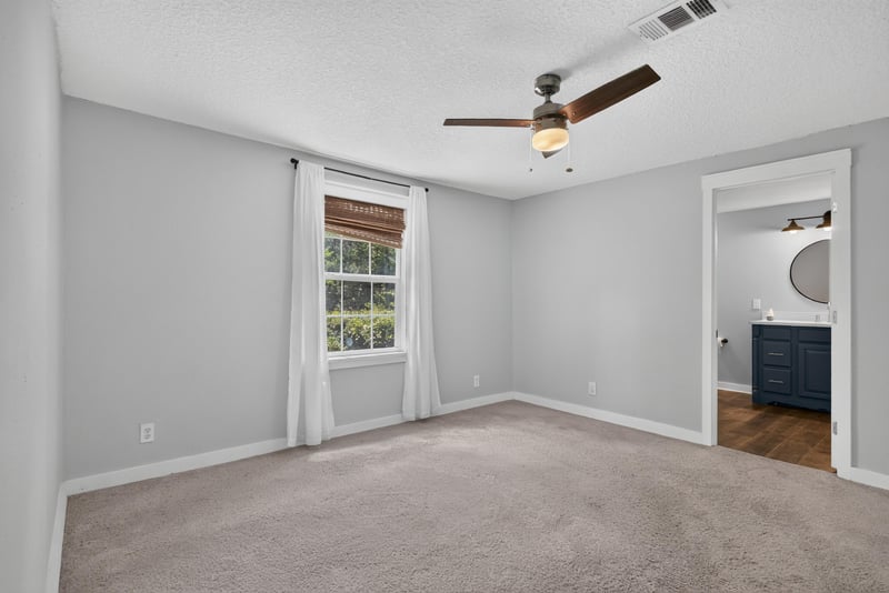 Empty room with ceiling fan and beamed ceiling at 4890 McAllister Rd, Middleburg, FL 32068