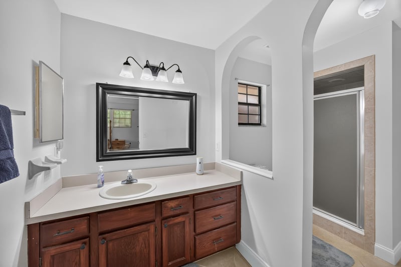 Bathroom vanity with mirror and lighting at 2435 Range Line Rd, Middleburg, FL