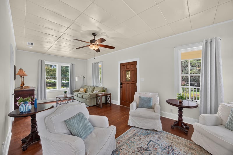 Living room with ceiling fan opening to dining room at 101 N Lake St, Crescent City, FL