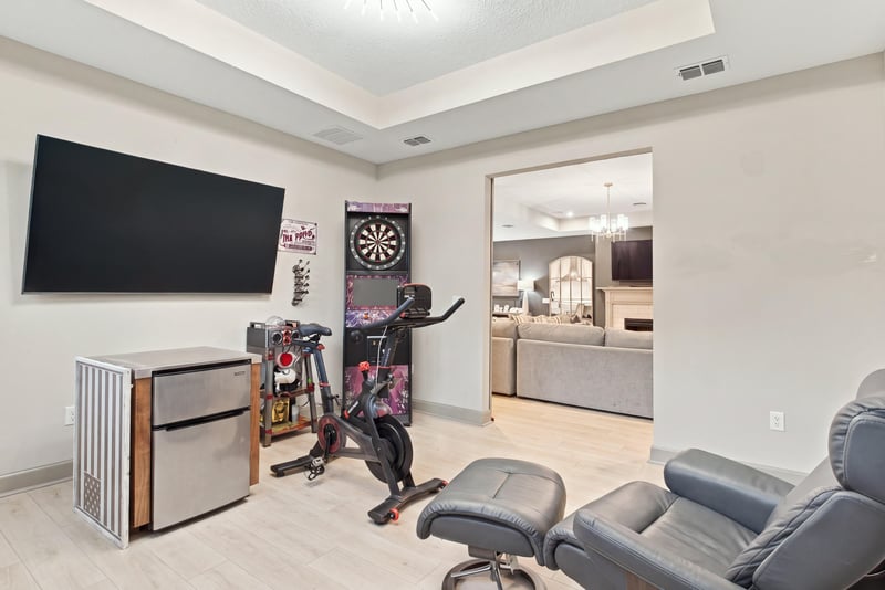 Game room with mounted TV and dartboard at 3921 Spyglass Hill Ln