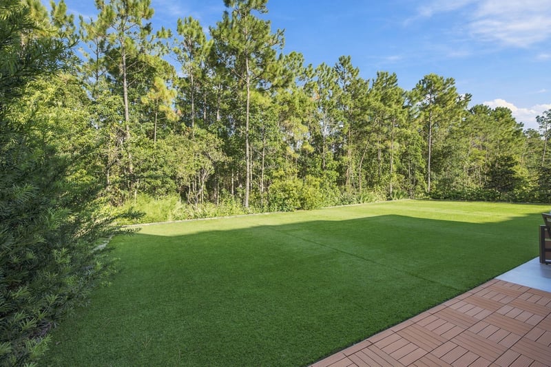 Open green yard bordered by trees at 907 Seagrove Dr, Ponte Vedra Beach, FL 32081