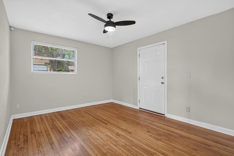 Bedroom with wood floors and exterior door at 217 Baisden Rd, Jacksonville, FL 32218