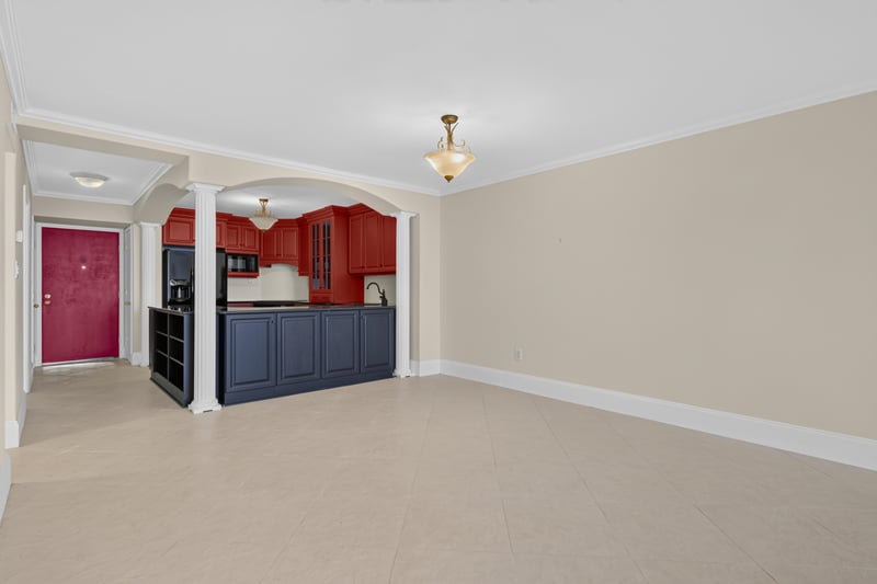 Open living area adjoining kitchen with red cabinets at 1301 1st St S