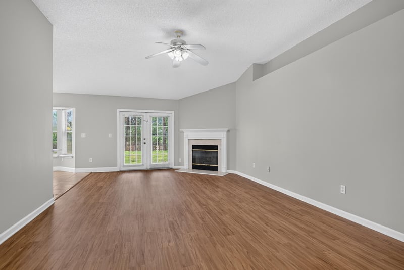 Living room with fireplace and wood floor at 12949 Chets Creek Dr S, Jacksonville, FL 32224