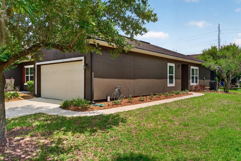 Side exterior view of garage and front window at 2378 Caney Oaks Dr, Jacksonville, FL