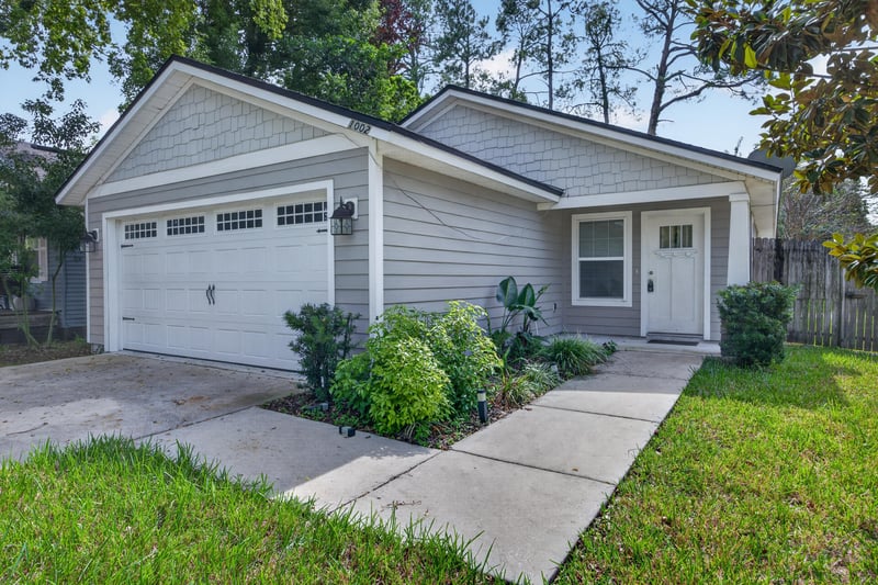 Front exterior with garage door and walkway at 1002 Ingleside Ave, Jacksonville, FL 32205