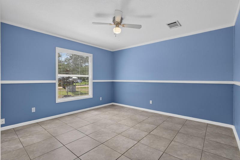 Primary bedroom empty with tile floor at 2549 Snapdragon Ave, Middleburg, FL 32068