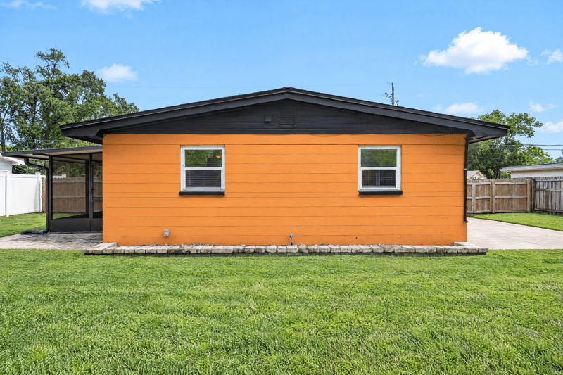 Back exterior with carport and open lawn at 4039 Habana Ave, Jacksonville, FL