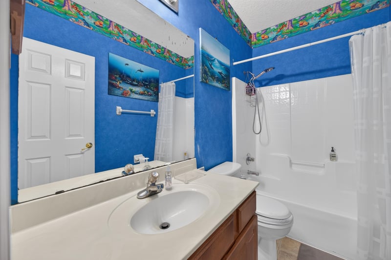 Bathroom with painted mural and tub at 2875 Pebblewood Ln, Orange Park, FL 32065