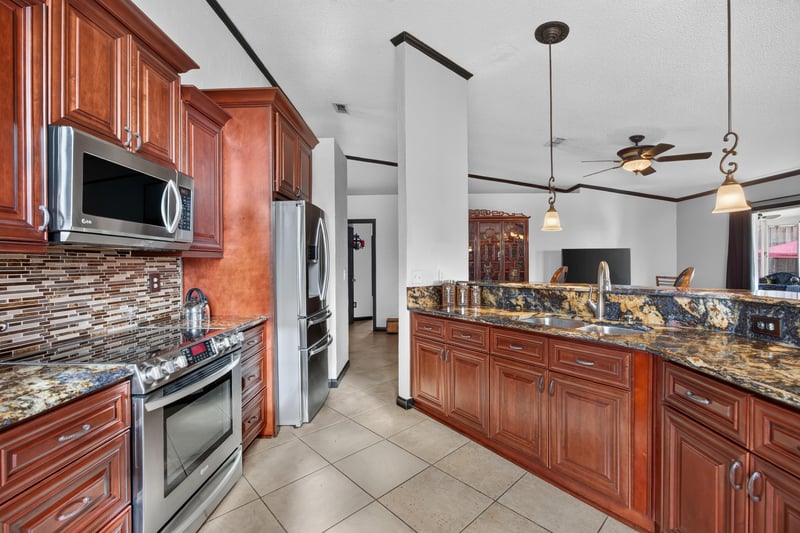 Kitchen with granite counters and appliances at 6931 Cane Grass Ln E, Jacksonville, FL 32244