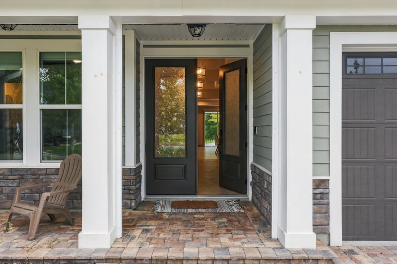 Front entry with glass double doors at 3921 Spyglass Hill Ln