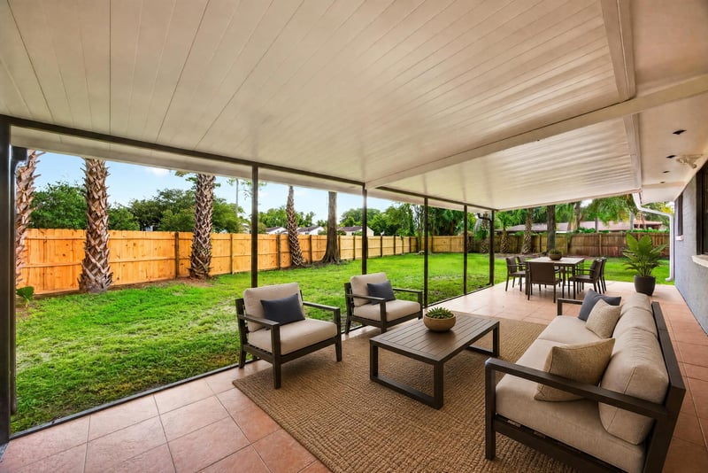Covered patio with virtually staged seating area at 4117 Wilcrest Ct, Jacksonville, FL 32277
