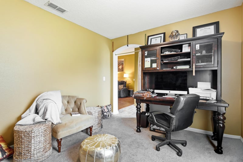 Home office with desk and built-in shelving at 7392 Timber Falls Ct