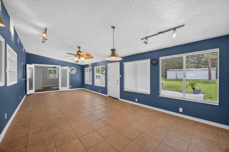 Lounge room with blue walls and tile flooring at 5843 Ovella Rd, Jacksonville, FL 32244