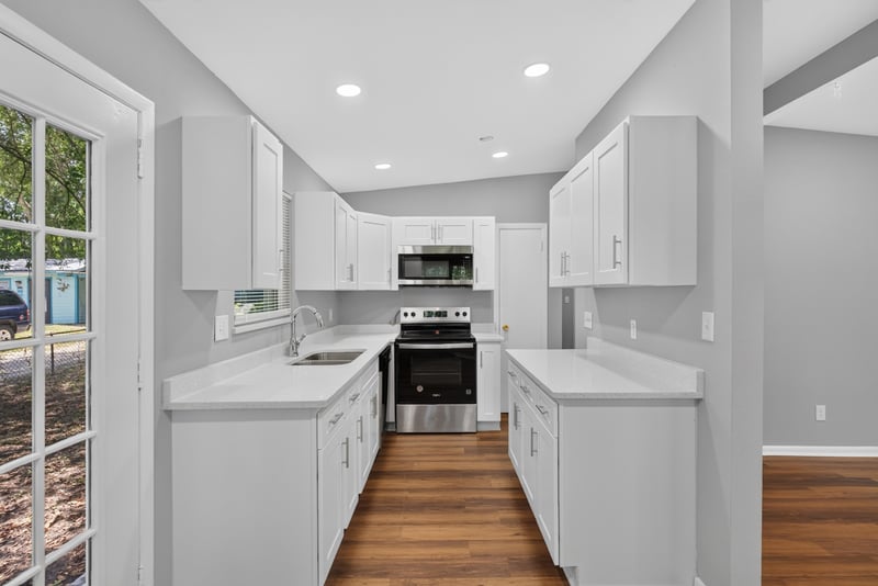 Kitchen view toward side door at 1928 Montmarte Dr, Jacksonville, FL 32210