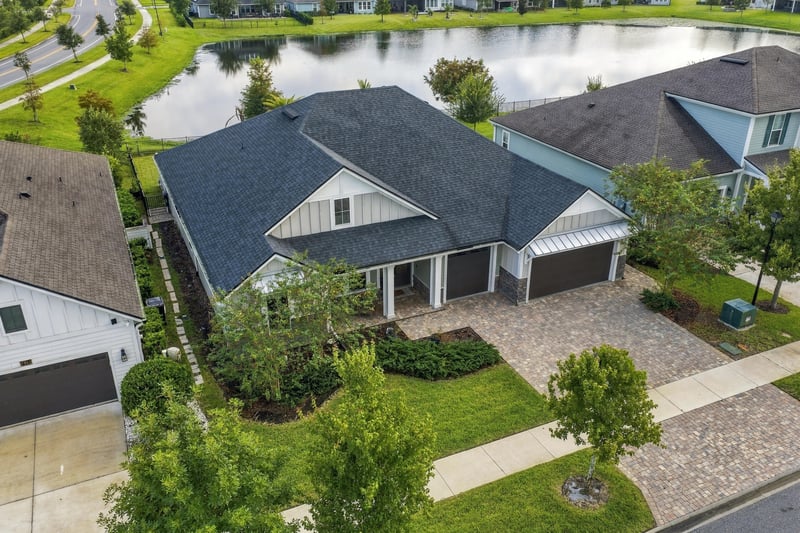 Aerial view of the home's roofline and backyard pond at 3921 Spyglass Hill Ln