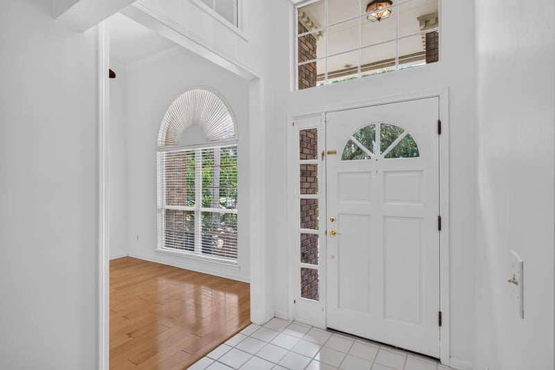 Entry foyer with front door and tile floor at 12810 Swamp Owl Ln