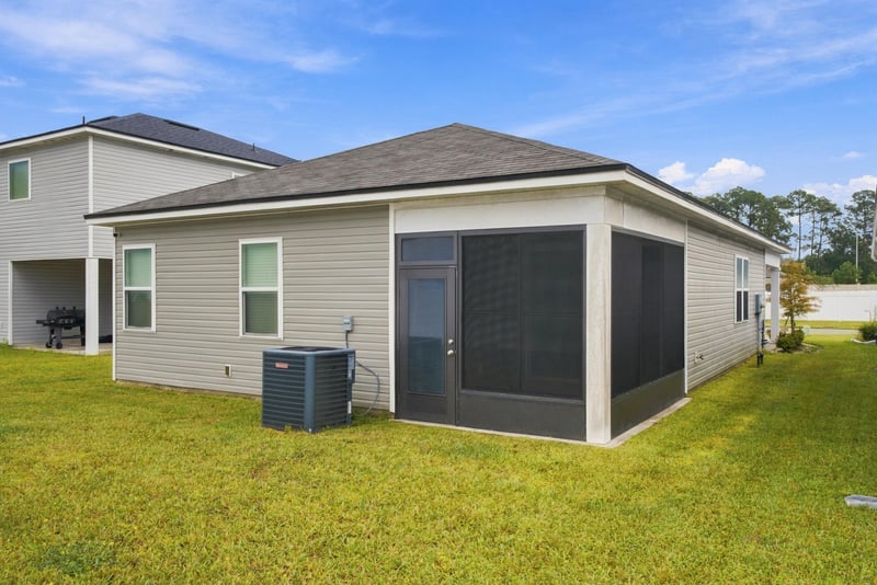 Interior room with sliding glass door to the porch at 7088 Mahogany Run Dr, Jacksonville, FL 32244