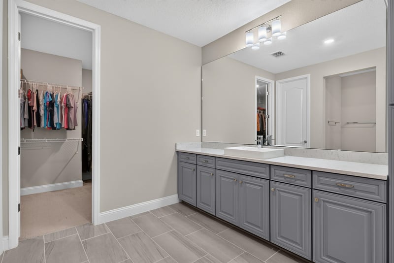 Primary bathroom vanity with closet door at 22 Azura Point