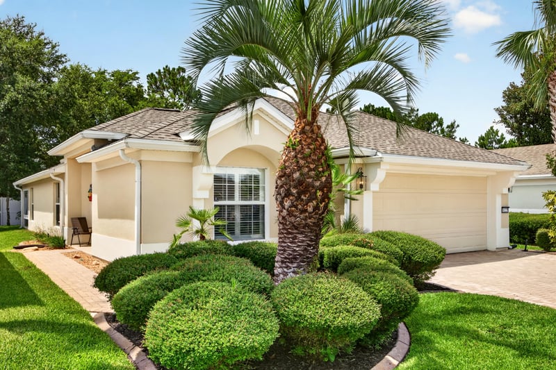 Front exterior with palm tree and landscaping at 11225 Water Spring Cir, Jacksonville, FL 32256