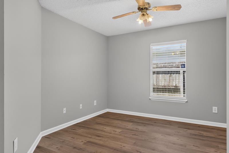 Bedroom with wood-look floor and window at 1108 Hidden Cove Cir S, Atlantic Beach, FL 32233