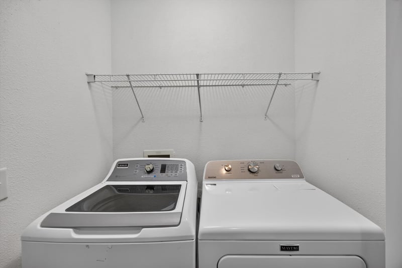 Laundry closet with washer and dryer at 1701 The Greens Way 1415, Jacksonville Beach, FL 32250