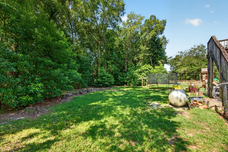Backyard lawn with mature trees at 1735 Hagans Ridge Ct